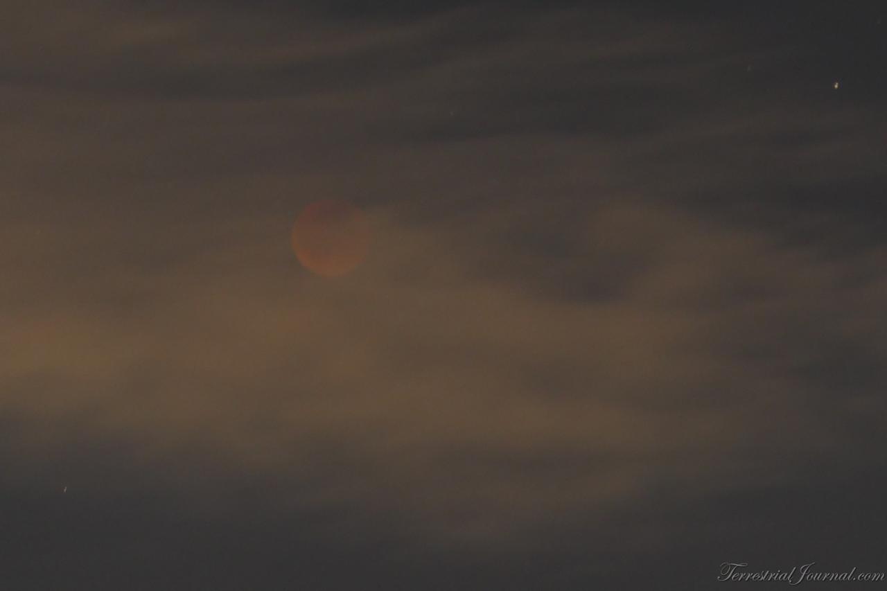 The cloud failed to fully conceal the Blood Moon.