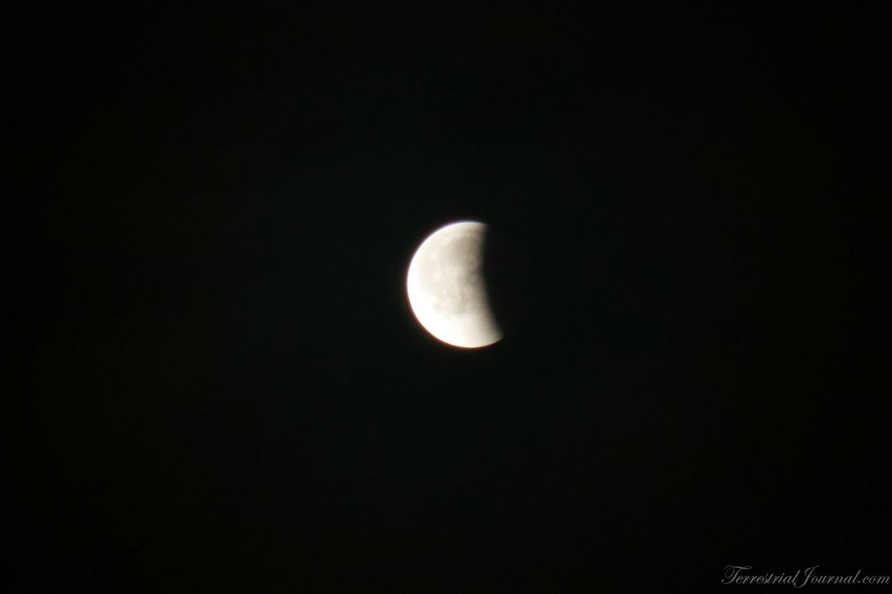 Some time later. This looks like a normal waning moon, except it's not - it's still partially eclipsed